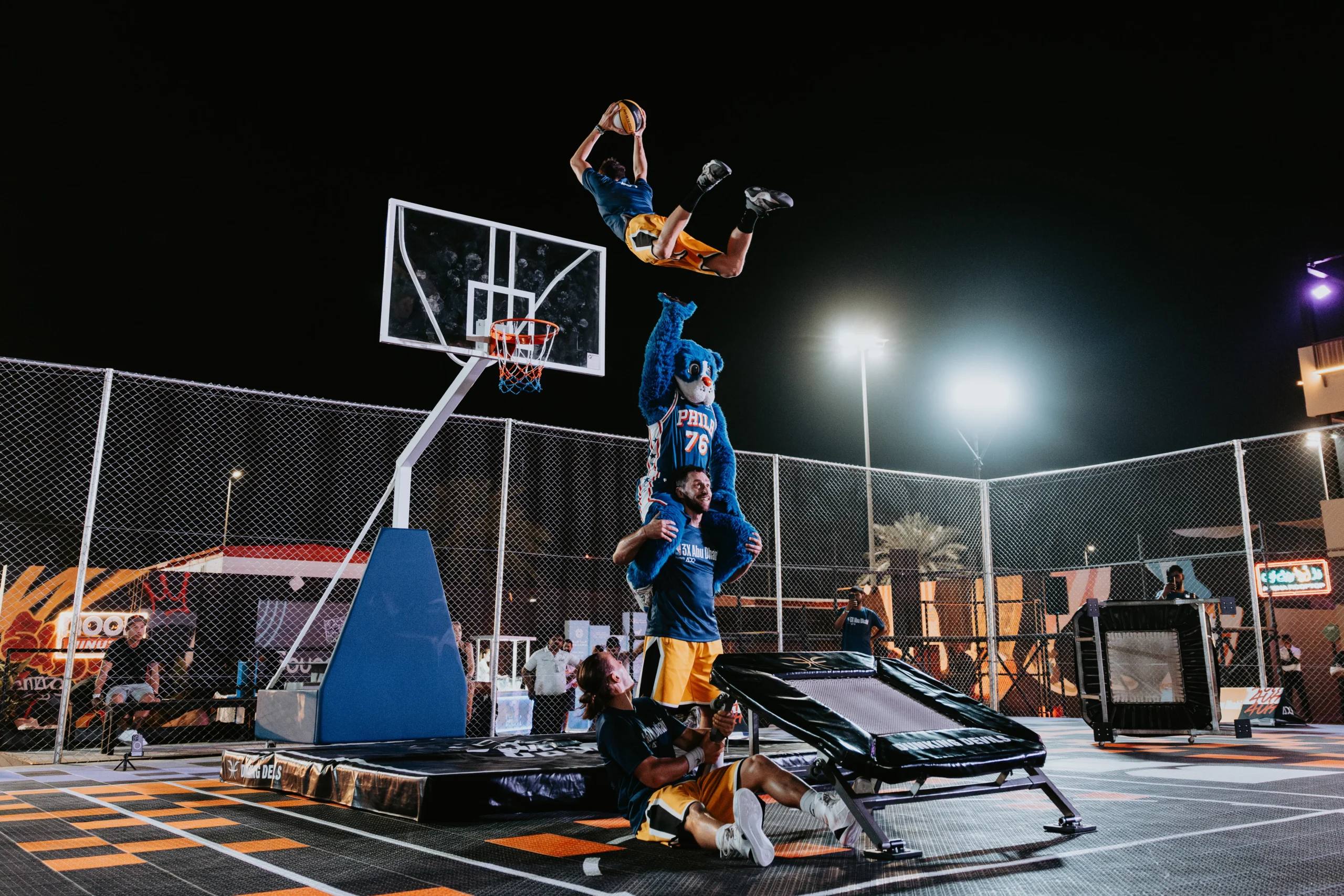 Dunking Devils athlete mid-air during an acrobatic dunk show.