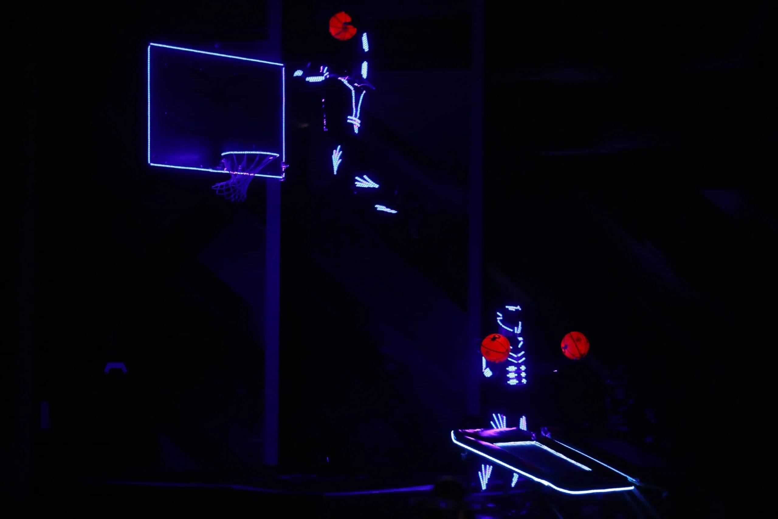 LED-lit basketball and acrobat during the Dunking Devils LED show.
