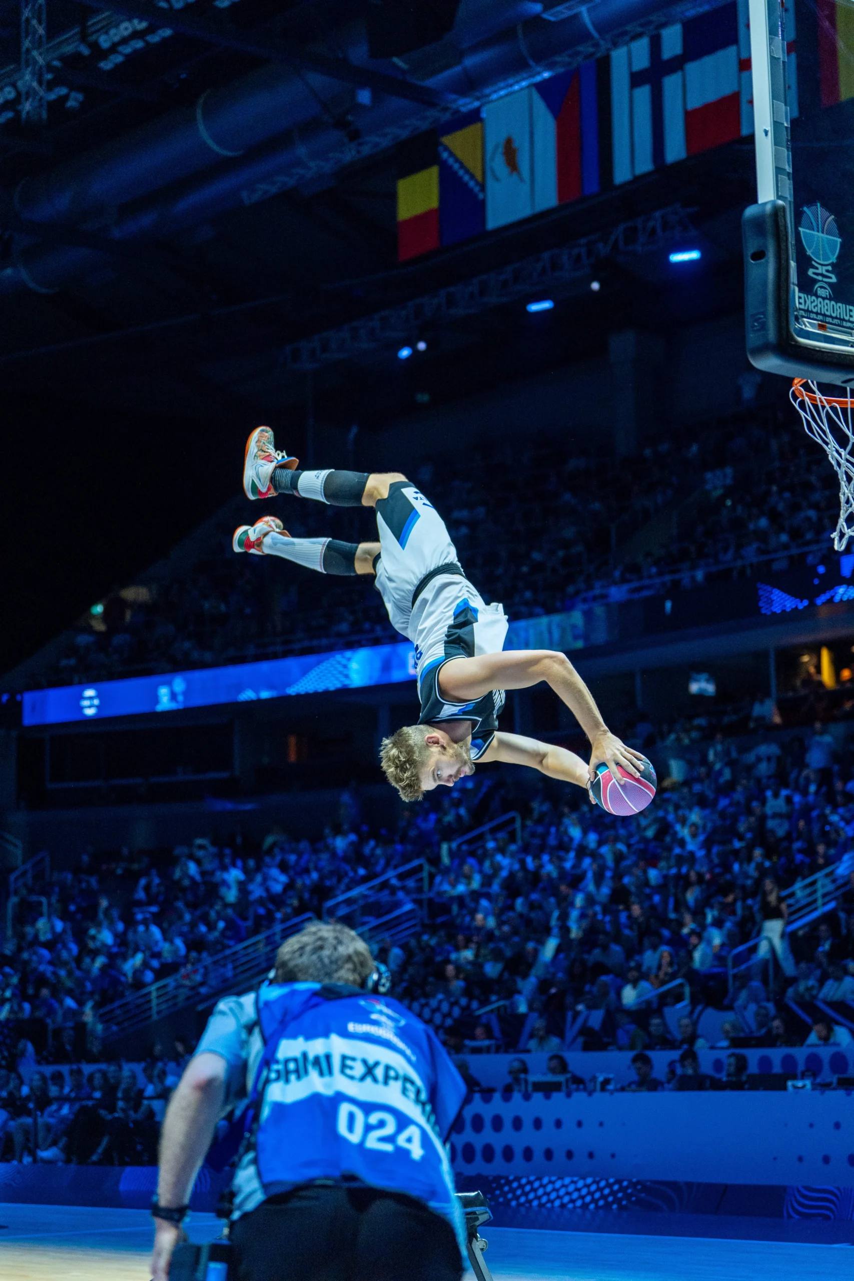 Dunking Devils performing acrobatic basketball for a packed arena.