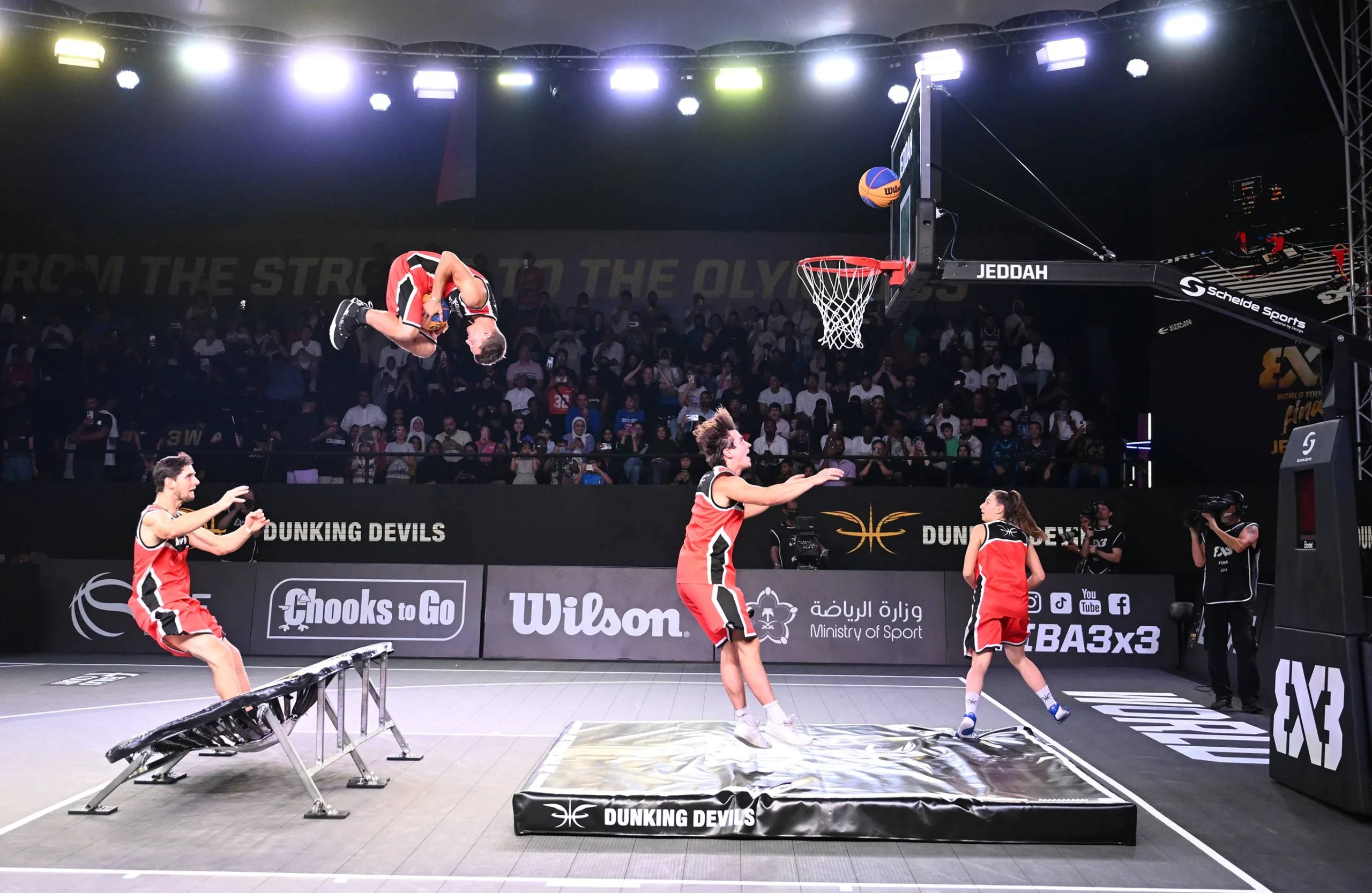 Dunking Devils athlete flying high above the hoop.